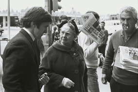 Graeme Blundell (market researcher) shocking another customer by purchasing ‘girlie mags’ at the newsstand outside Young & Jacksons Hotel, Swanston St, Melbourne, in The Naked Bunyip